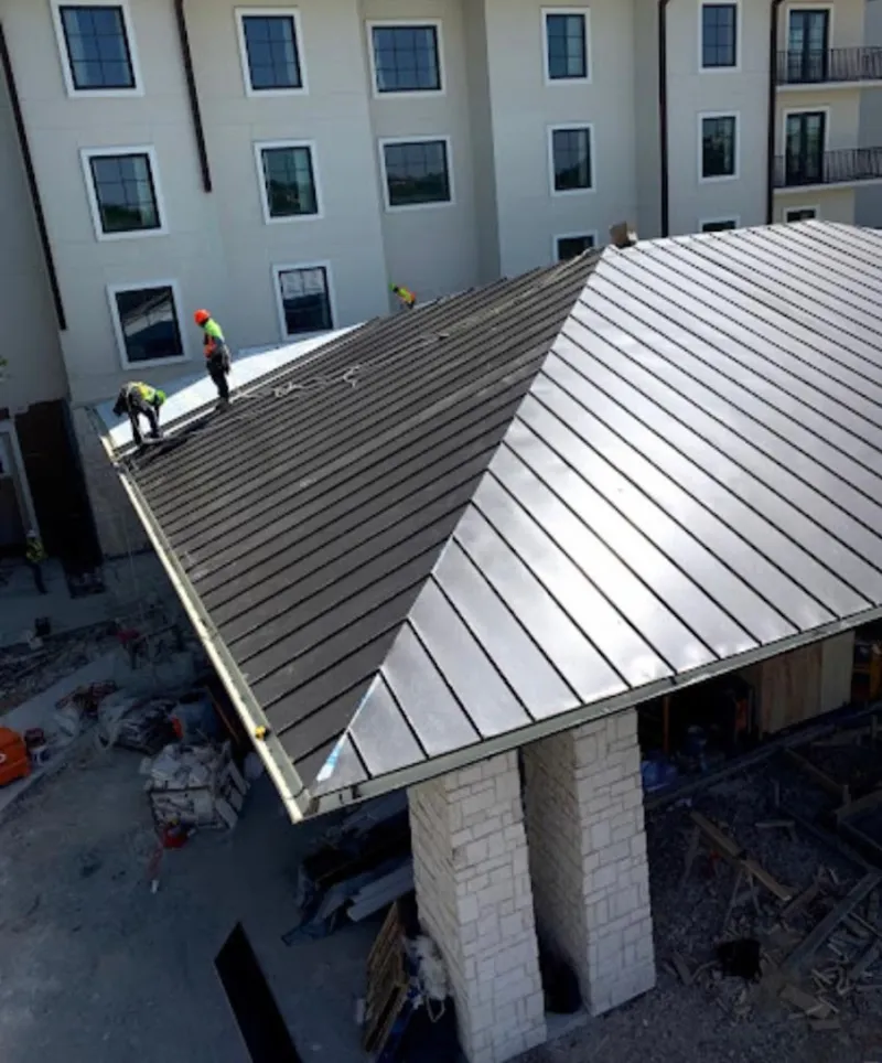 Crew installing standing seam metal roof panels on a commercial project in Casa de Oro-Mount Helix